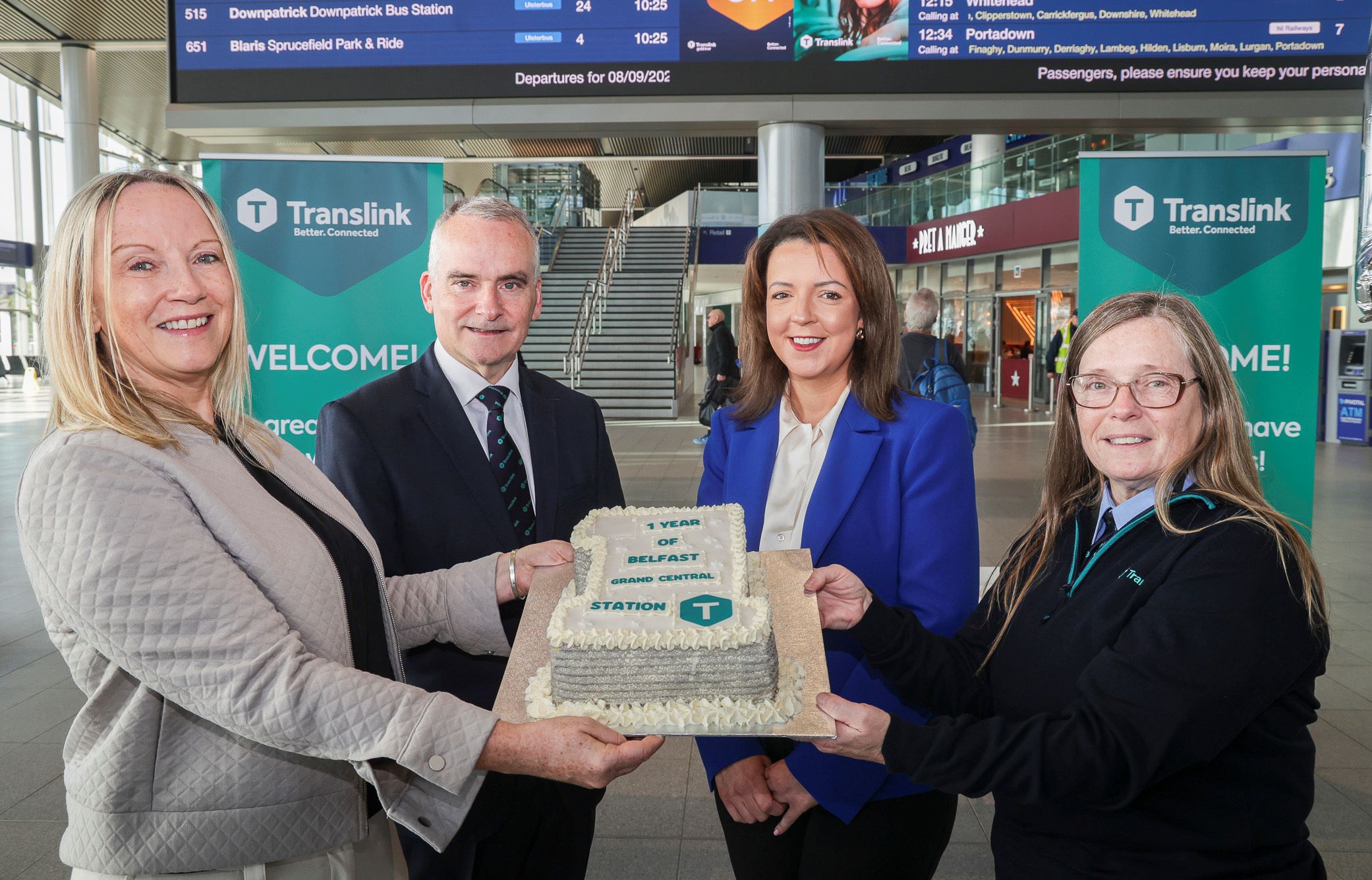 Translink Chief Executive, Chris Conway, cuts a cake at an event to mark the first anniversary of Belfast Grand Central Station
