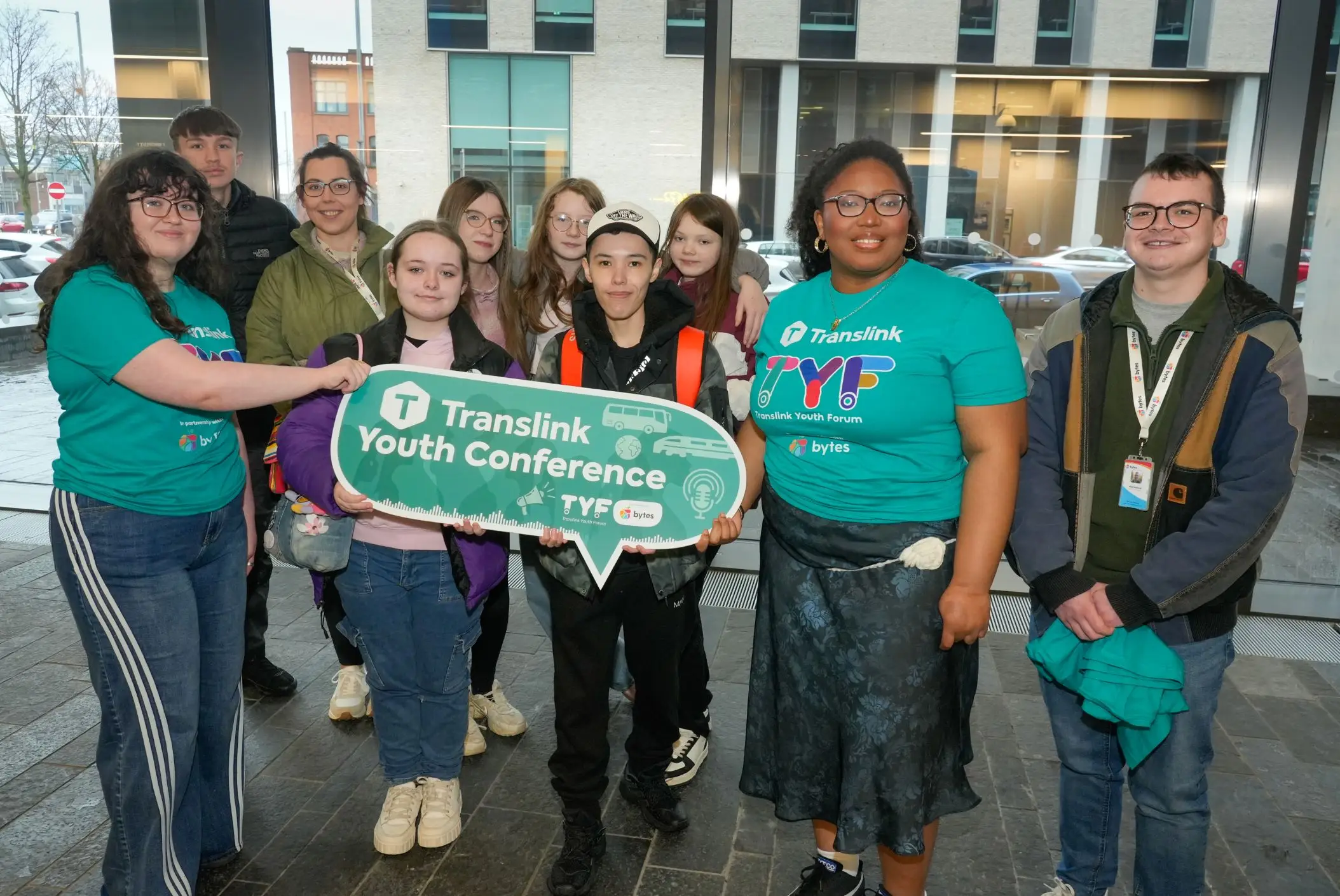 Youth Forum 2025 Image 2 A group of young people holding a placard with text on it saying 'Translink Youth Conference'.