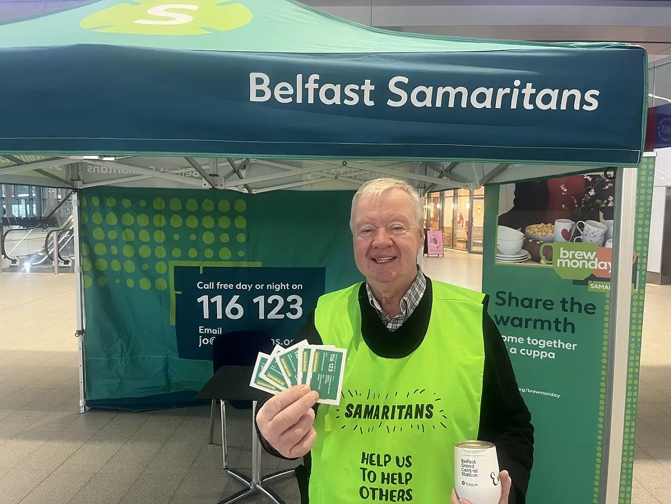 A photo of a member of the Samaritans volunteering at Belfast Grand Central Station.