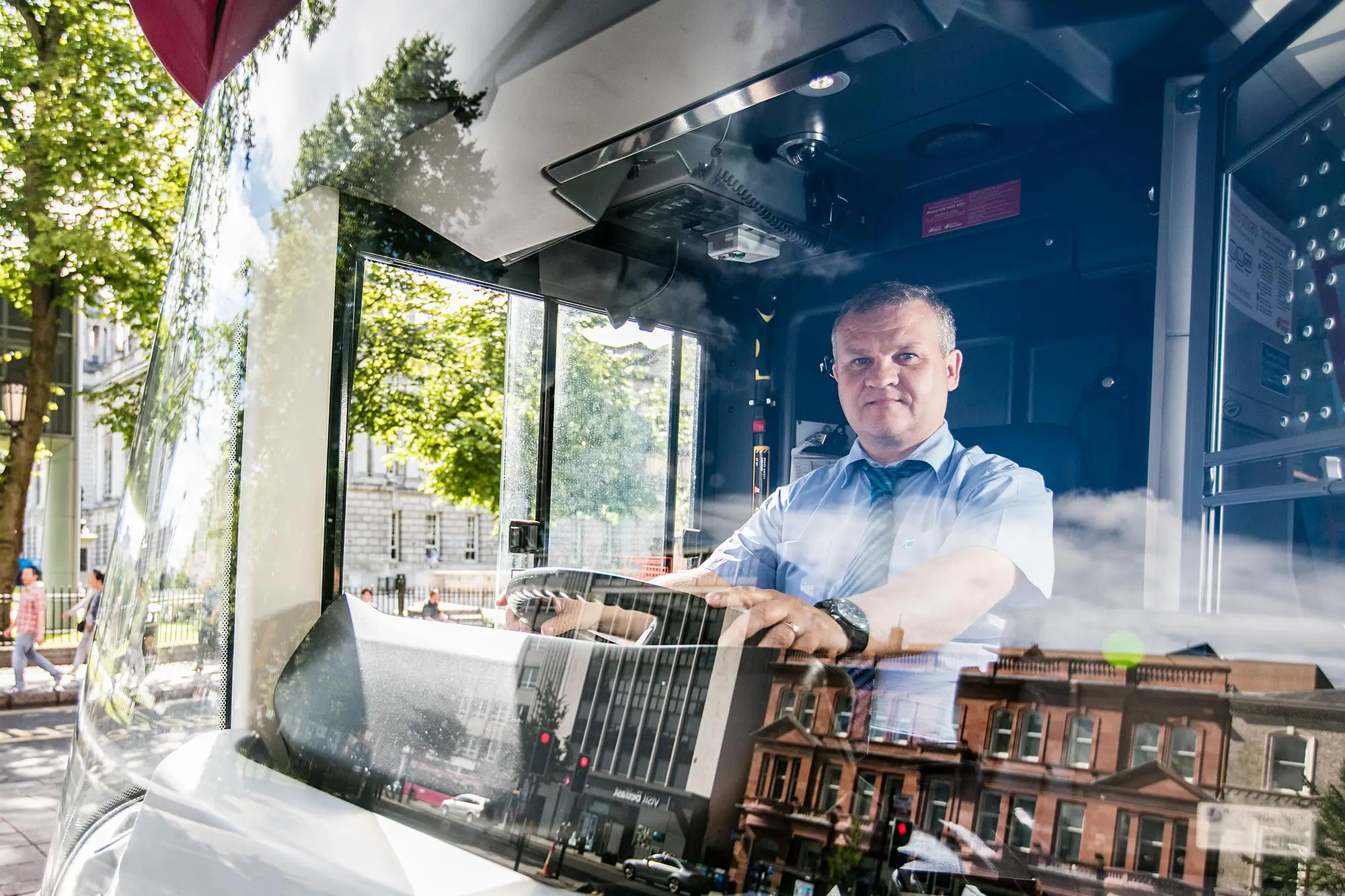 bus metro summer staff A Translink Metro bus driver seen through the windshield of his bus