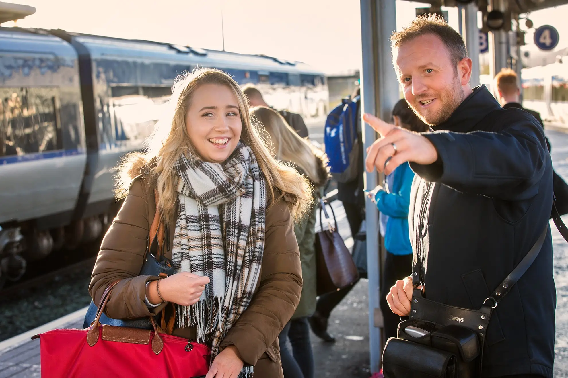 Conductor on platform with passenger