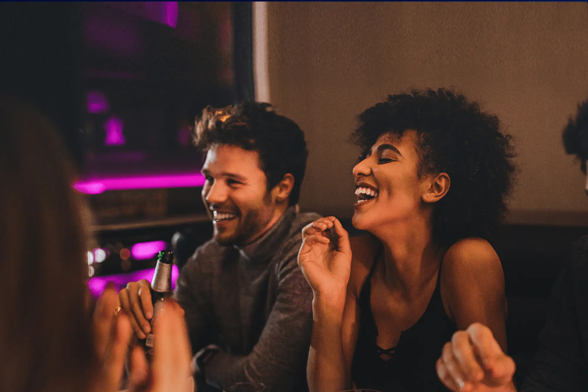 A group of friends laughing and enjoying a night out