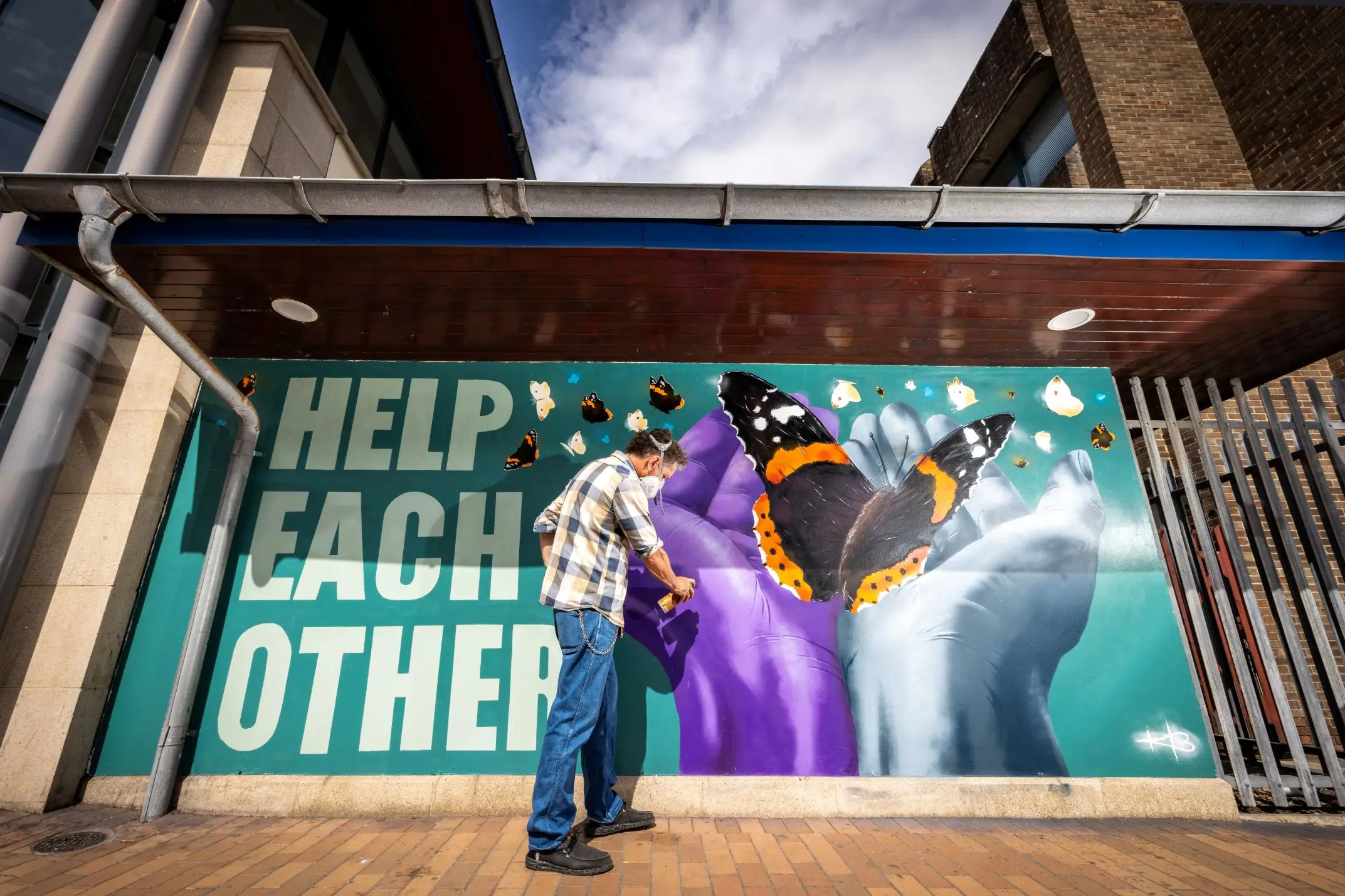 Downpatrick Mural 2 A photo of artist Kieron Black working on his new mural at Downpatrick Bus Station.