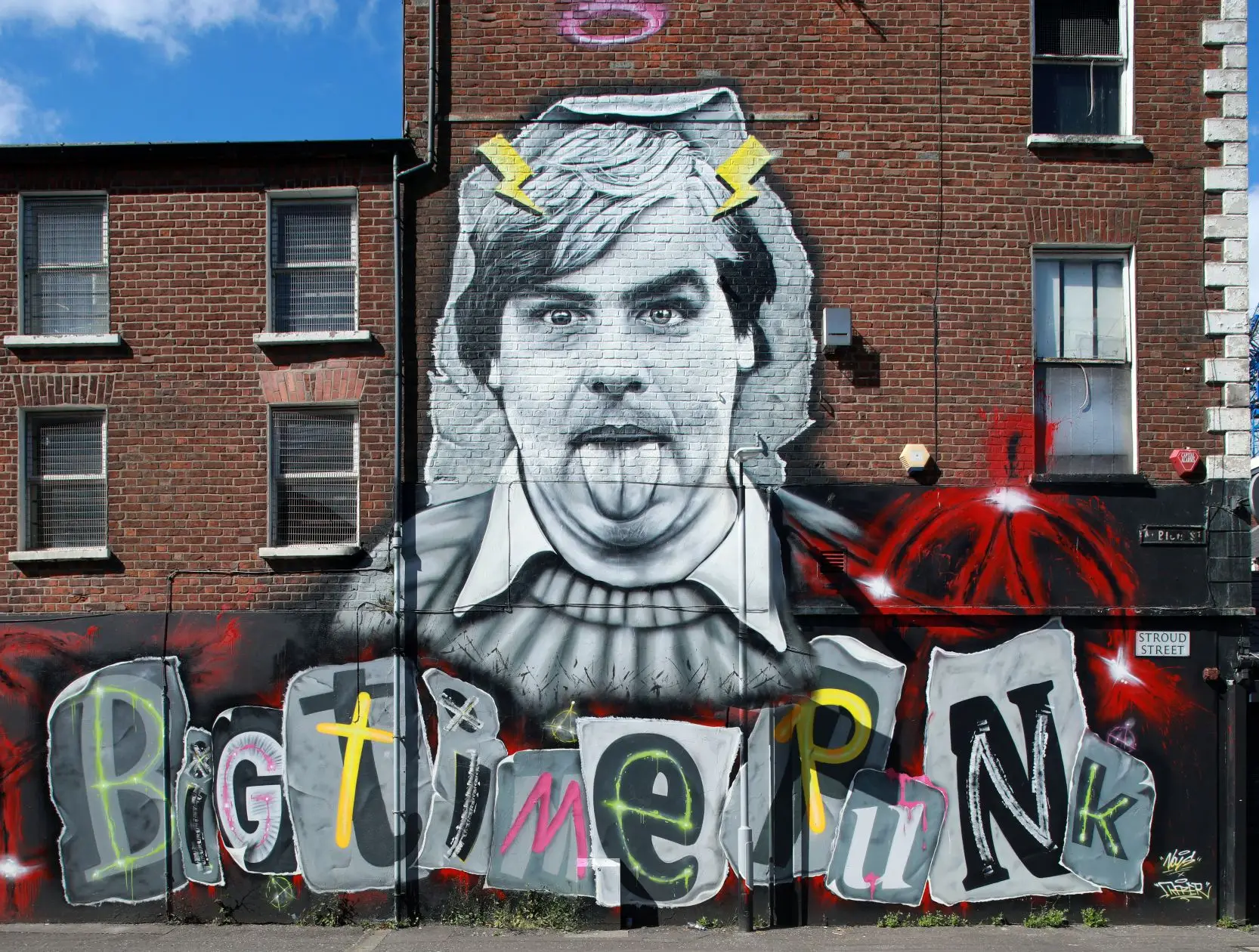 Terry Hooley A photo of a mural showing Belfast record shop owner Terry Hooley sticking his tongue out.